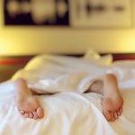 Is Sleep Making You Tired? feet at the end of the bed indicating sleeping
